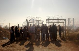 Farmers waiting to access their olive groves behind the Barrier, next to Beit Surik village (Ramallah), 31 October, 2019. ©  Photo by OCHA