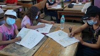 Girls participating in the drawing corner. 5 July 2021. Photo by OCHA.