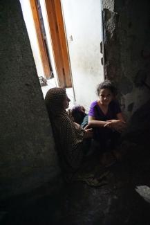 Abeer al Nemnem and her daughters sitting at the porch of their house in Ash Shati Refugee Camp, Gaza, May 2017. ©  Photo by OCHA.