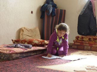 Displaced Palestinian girl in temporary accommodation in Gaza. © Photo by OCHA, February 2015.
