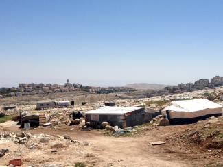 Jabal Al Baba (Jerusalem), a Bedouin community at risk of forcible transfer. In the background Ma&#039;ale Adummim settlement. Photo by OCHA