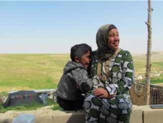 Shifaa Abu Iram and her son sitting in Halaweh community, Massafer Yatta (Firing zone 918).  © Photo by OCHA