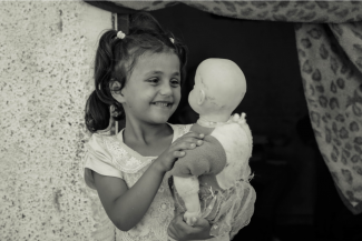 Rimas, 7, plays with her doll, at home in Jabalia on 21 August 2019. ©  Photo by Ahmed Mashharawi, NRC