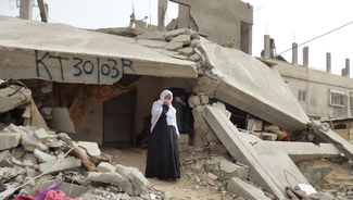 Woman living in debris of her destroyed house in east Khan Younis. February 2015. Photo by OCHA
