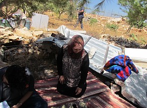 A Palestinian mother of four, resident of Jourat al Khiel, sitting on the belongings of her family following the demolition of their home by the Israeli authorities on 16 August 2016 A Palestinian mother of four, resident of Jourat al Khiel, sitting on the belongings of her family following the demolition of their home by the Israeli authorities on 16 August 2016