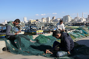 Palestinian fishers preparing their nets on the shore of Gaza. December 2018. © Photo by OCHA Palestinian fishers preparing their nets on the shore of Gaza. December 2018. © Photo by OCHA