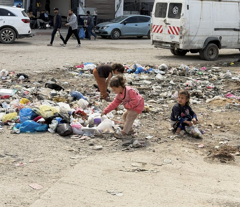 Children rummage through solid waste at a displacement site affected by pests and rodents in Gaza city, April 2026. Photo by OCHA