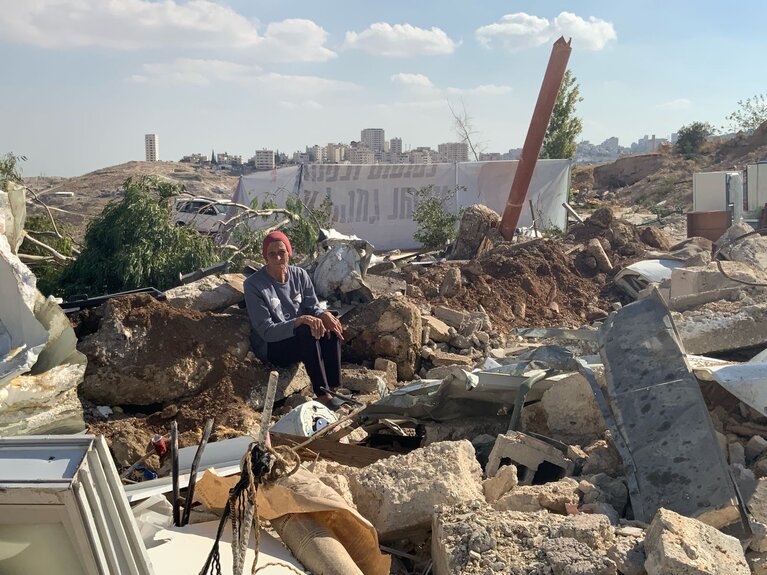 A Palestinian sitting amid destruction following the demolition of 20 structures in Az Za'ayyem Bedouins community, Jerusalem. Photo by OCHA