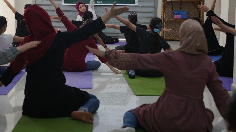 Women attending a yoga session at AISHA, 2020. Photo by AISHA.
