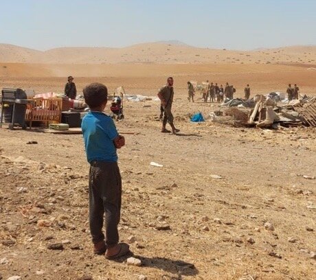 Palestinian boy looks on as Israeli soldiers destroy and confiscate residents’ belongings in Humsa – Al Bqai’a, 7 July 2021. Picture provided by community.