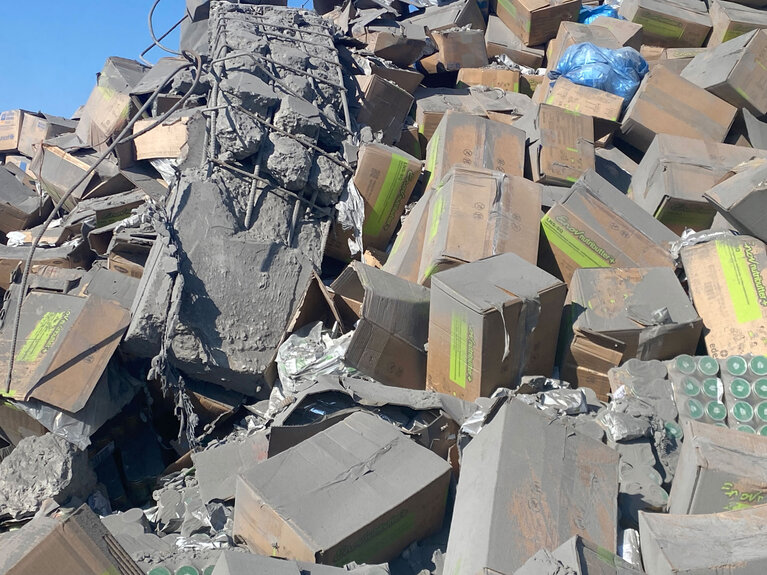 Damaged nutrition supplies following an Israeli airstrike that heavily damaged a humanitarian warehouse adjacent to the targeted building in Deir al Balah. Photo by Ard El Insan Palestinian Benevolent Association (AEI)