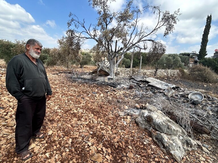 A beekeeper in the northern West Bank whose agricultural structure and equipment were burned by people believed to be settlers. Nearby trees were also damaged or destroyed by fire, 20 June 2026. Photo: OCHA