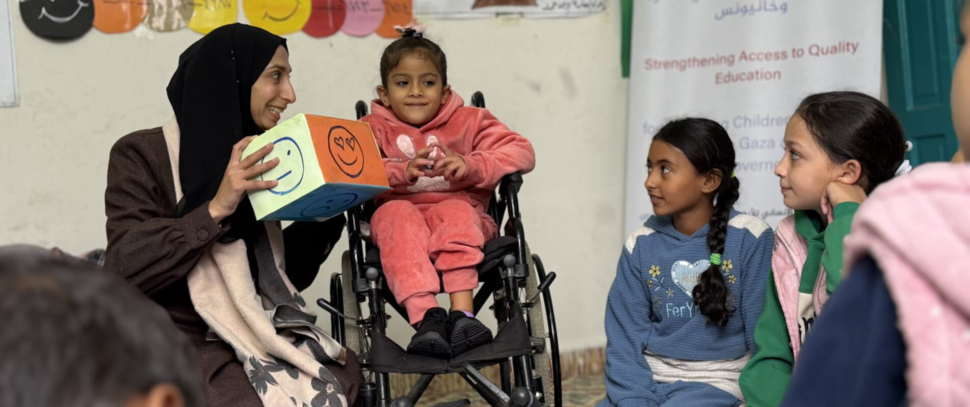 Six-year-old Dana (seated on a wheelchair) at the project centre where she receives education and psychosocial support. Photo by PSCF, 11 December 2025.