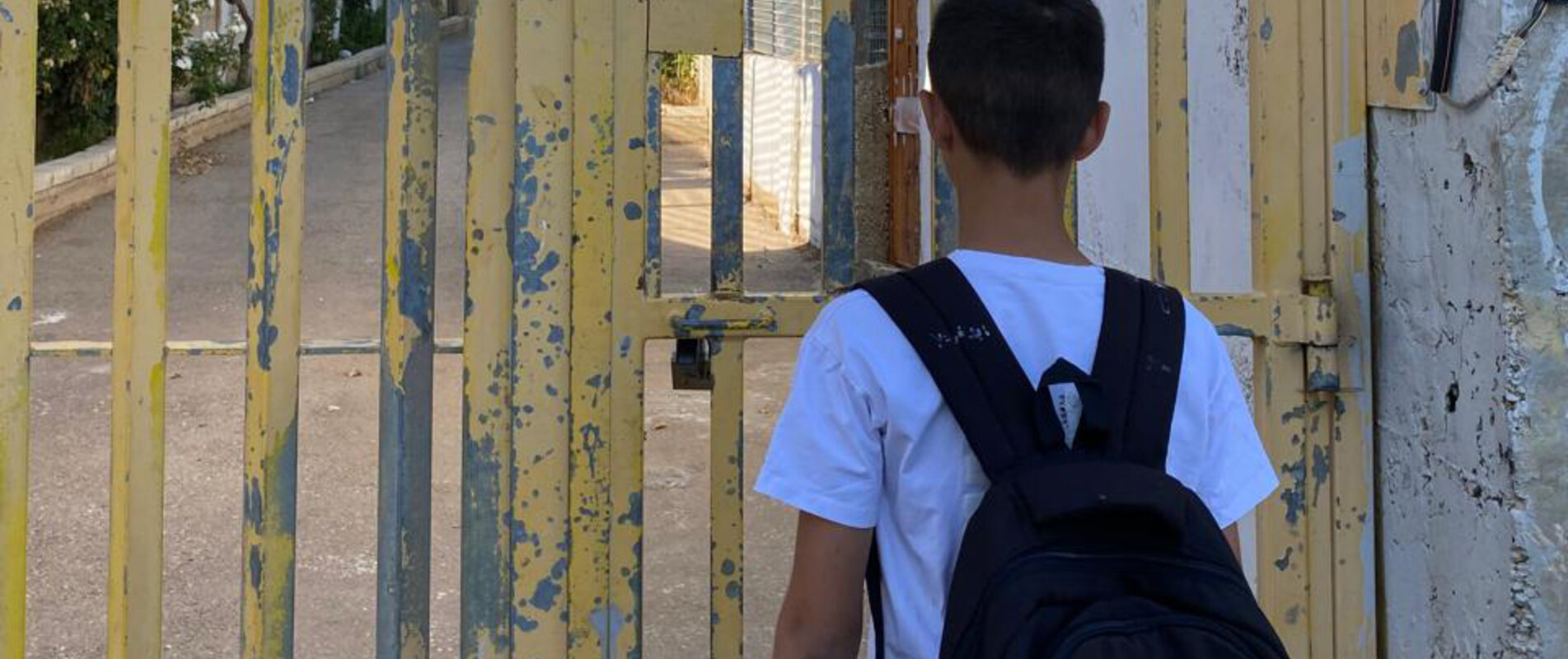 The son of Saadat Gharib standing in front of a gate installed by the Israeli military. The gate controls access to his family’s home, now encircled by settlement infrastructure. Photo by Shafea Jalamneh / Médecins du Monde Spain, Beit Ijza, East Jerusalem.