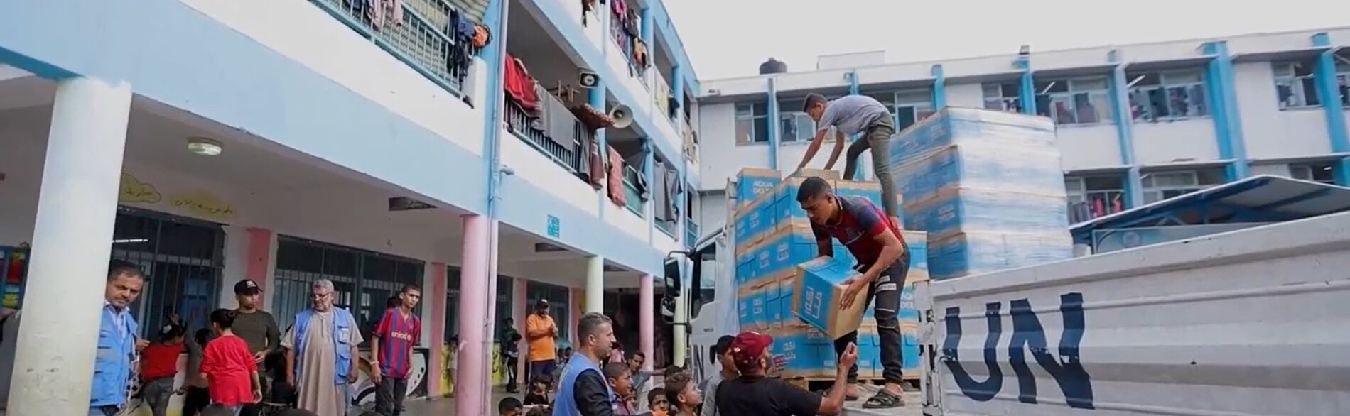Aid distribution in an UNRWA facility hosting displaced Palestinian families. Screenshot from a video by UNICEF