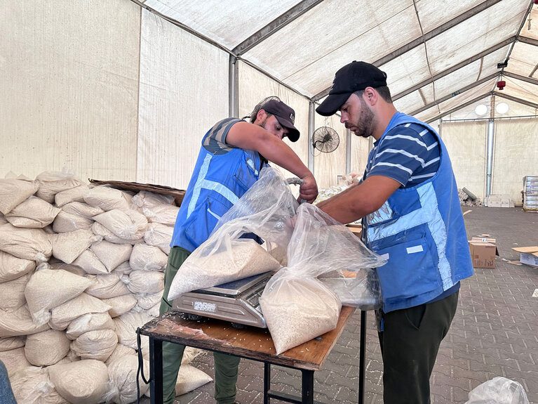 Packaging food parcels in a United Nations facility. Photo by UNRWA/Hussein Owda